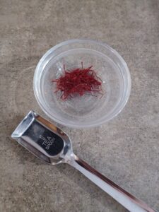 saffron threads measured into a small bowl